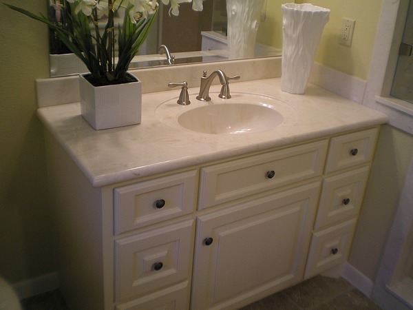 Bathroom Remodeling New Light Tan Solid Surface Sink Vanity with White Painted Cabinets, New Brushed Silver Hardware and Tan Tile Flooring