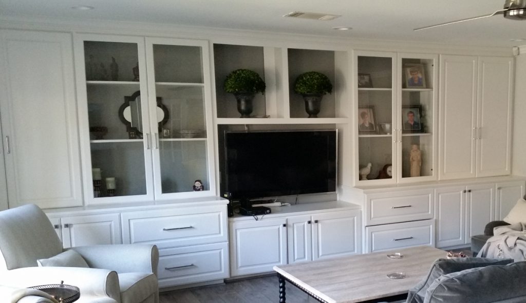 Home Remodeling Project Picture Entertainment Center New Cabinets with Glass Doors. New White Paint and Hardware.