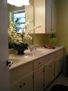 Bathroom Remodeling New Countertop with Dual Sinks and Brushed Silver Faucet Hardware, New Off White Painted Cabinets, New Tile Flooring