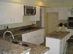 Kitchen Remodeling New Granite Countertops and Appliances with gas stove, New White Cabinet Paint and Hardware, New Kitchen Sink and Faucet.