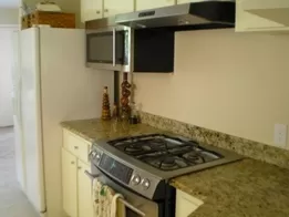 Kitchen Remodeling New Stainless Steel Gas Range with Hood Vent, Microwave and Granite Countertops