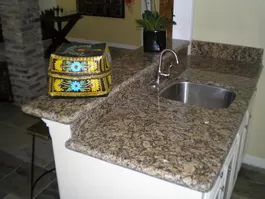 Wet Bar Project Picture with New Granite Countertop, Faucet, Sink, Cabinets, Drink Ledge and White Paint