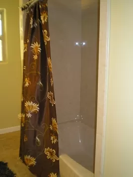 Bathroom Remodeling New Bath Tub with Shower in Light Tan Marbled Design, New Darker Marbled Tan Ceramic Tile Flooring