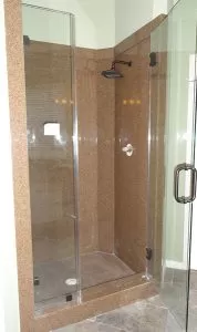 Bathroom Remodeling New Granite Shower with Bronze Showerhead and Glass Entry